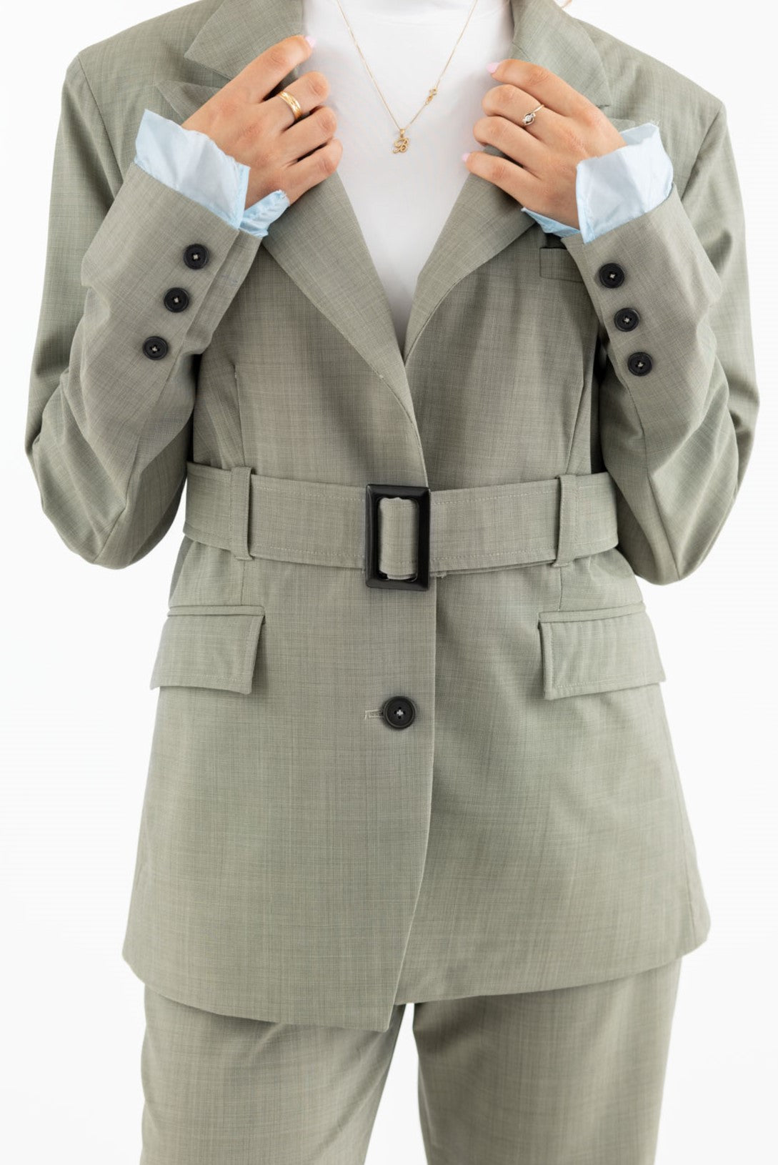 Wool blazer in sage green with belt and exposed light blue lining on the sleeves