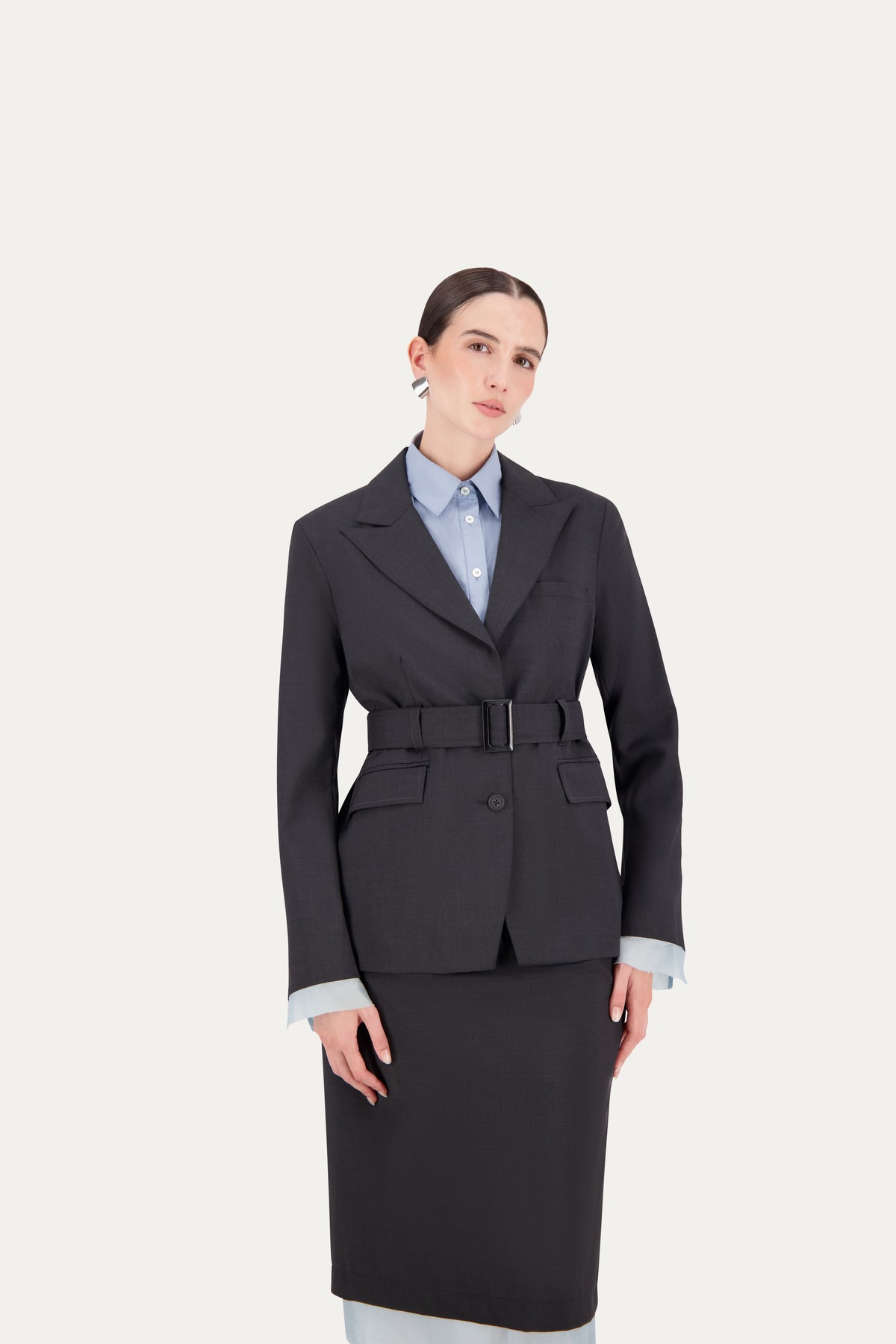 Wool blazer in grey with belt and exposed light blue lining on the sleeves